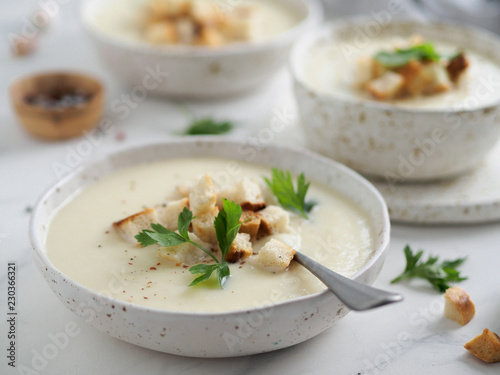 cauliflower potato soup puree on white marble tabletop, Creamy cauliflower soup with toasted bread croutons. Vegetarian healthy food concept. Ideas and recipes for winter meal. Copy space