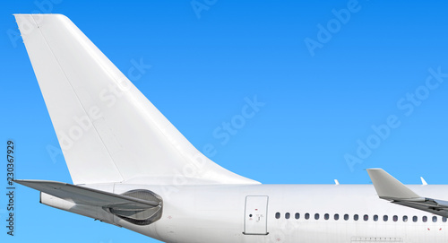 Modern passenger jet aircraft side tail silhouette with aircraft parts wing winglet passenger window aft exit stabilizer fin antenna jet engine exhaust design air travel isolated on sky white scheme photo