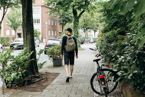 Bild auf Leinwand Tourist with a backpack is looking for booked online accommodation in an unfamil