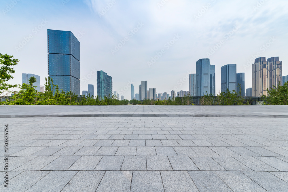 Panoramic skyline and modern business office buildings with empty road,empty concrete square floor Panoramic skyline and modern business office buildings with empty road,empty concrete square floor