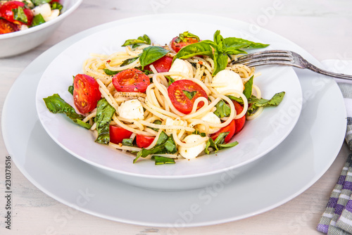 Italian pasta - Spaghetti caprese with mini mozzarella and cherry tomatoes.