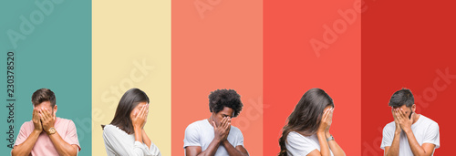 Collage of different ethnics young people over colorful stripes isolated background with sad expression covering face with hands while crying. Depression concept.