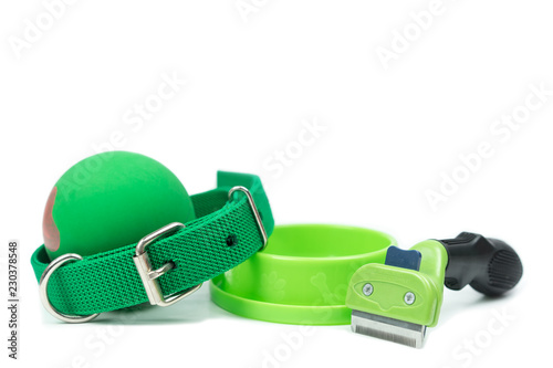 Pet accessories concept.  Bowls, Rubber toy, Collars and brush on isolated white background.on isolated white background.