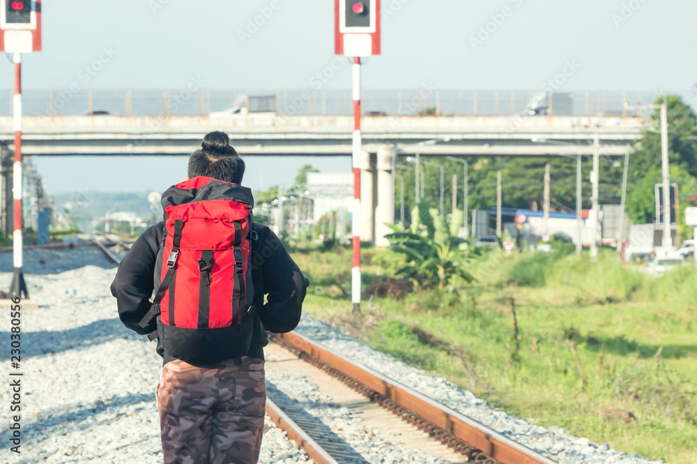 Young man with backpack waiting for next the train station Young man with backpack waiting for next the train station