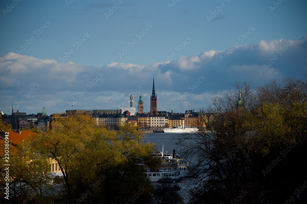 Water view over Stockholm an late autumn day, snowy, sun and clear sky over boats and landmarks