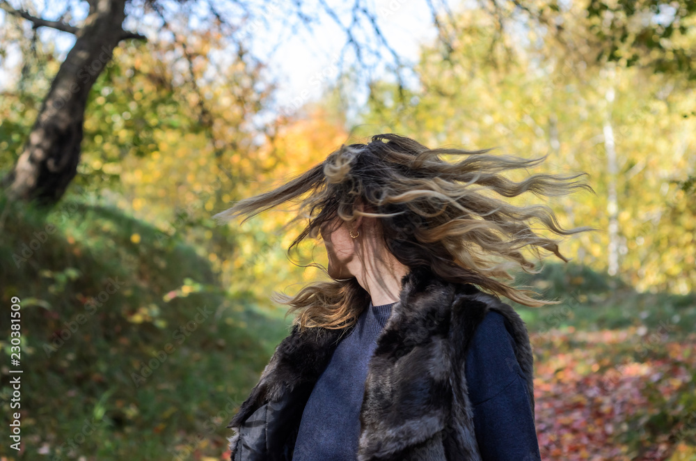 Young beautiful girl with long hair walks in the autumn forest Young beautiful girl with long hair walks in the autumn forest