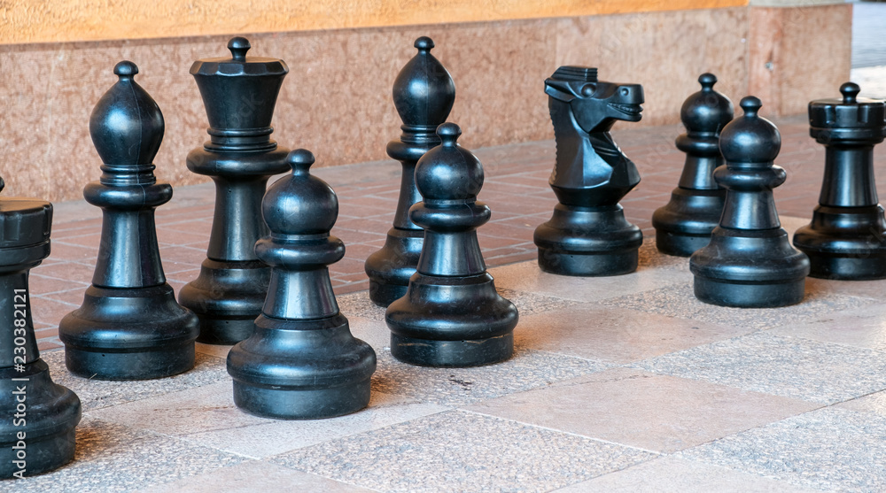 Giant chess board with black chess pieces. Color image Giant chess board with black chess pieces. Color image