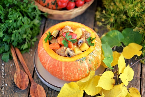 Vegetable stew with pork, potatoes, red pepper, carrots, mushrooms, eggplant in pumpkin.