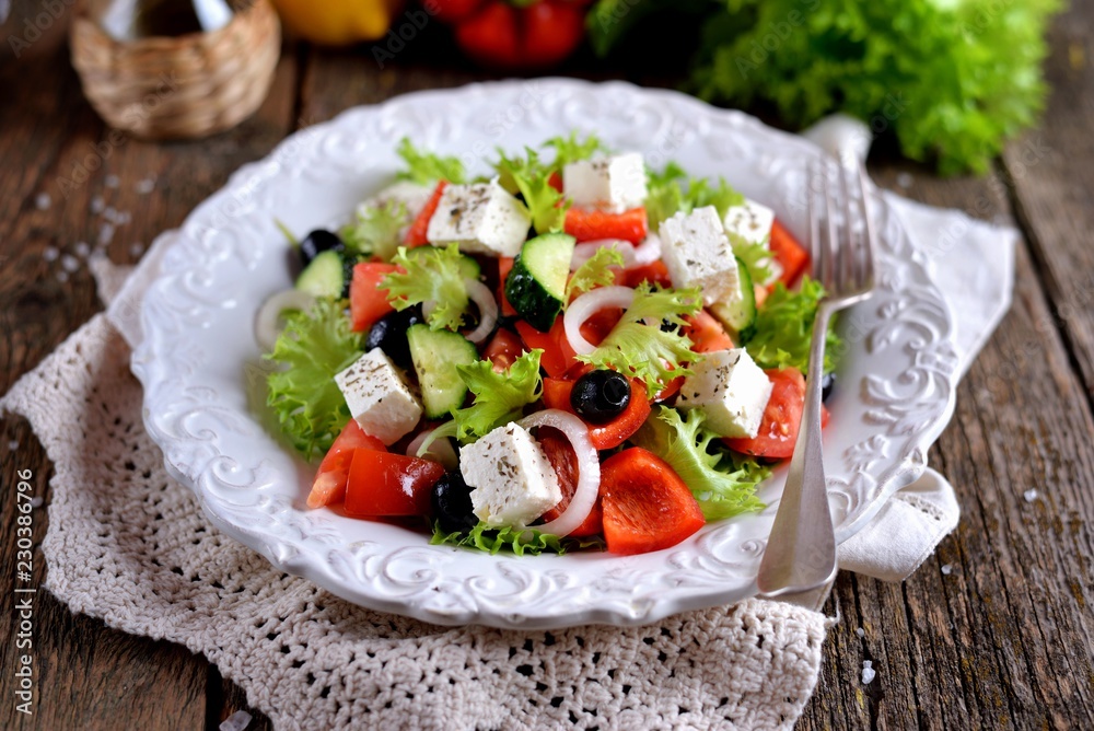 Classic Greek salad from tomatoes, cucumbers, red pepper, onion with olives, oregano and feta cheese. Classic Greek salad from tomatoes, cucumbers, red pepper, onion with olives, oregano and feta cheese.