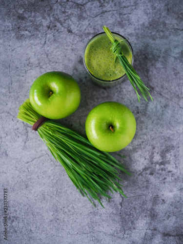 Detox juice mix between wheat grass and apple on top view. Nutrition food concept. Healthy drinking.
