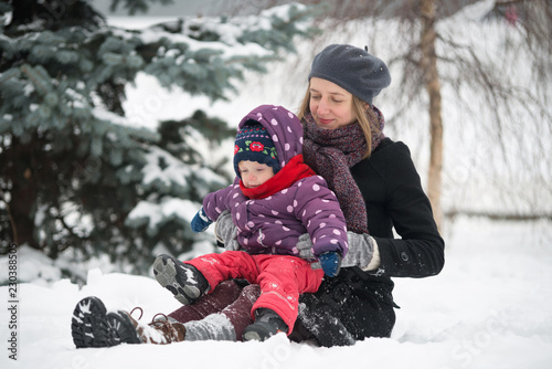 Woman playing with a child in the snow