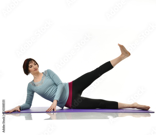 Female fitness instructor doing stretching for hands legs abdominals bar exercise in gym work out isolated on white 