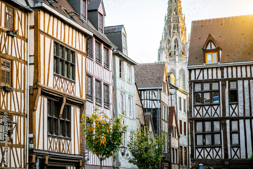 Fototapeta Naklejka Na Ścianę i Meble -  Street view with beautiful old buildings and cathedral tower on the background in Rouen city, the capital of Normandy region in France