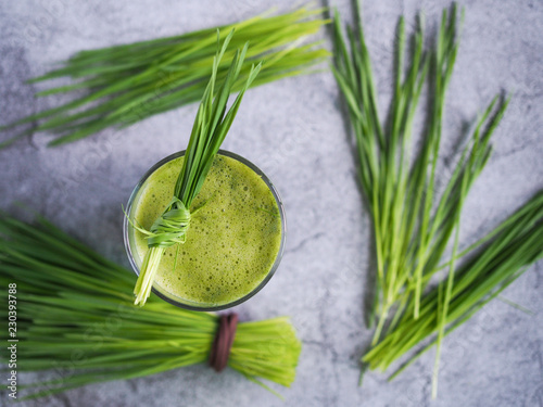 Fresh wheat grass juice and wheatgrass plant for health on top view. Nutrition food. photo