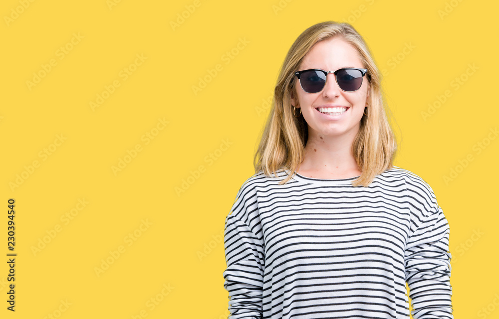 Beautiful young woman wearing sunglasses over isolated background with a happy and cool smile on face. Lucky person. Beautiful young woman wearing sunglasses over isolated background with a happy and cool smile on face. Lucky person.