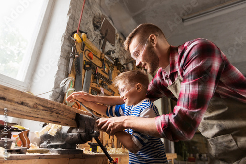 Canvastavla family, carpentry, woodwork and people concept - happy father and little son wit