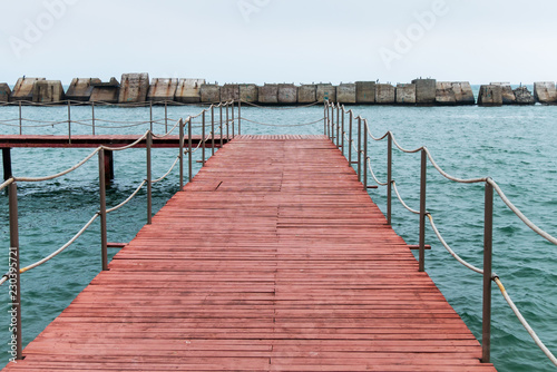 Wallpaper Mural Wooden pier in sea harbor in cloudy autumn day Torontodigital.ca