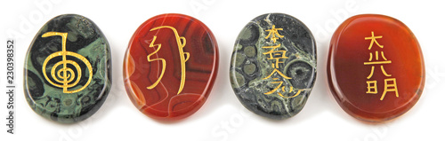 Принти на полотні The four major Reiki Healing Symbols - etched into palm stones made of Carnelian