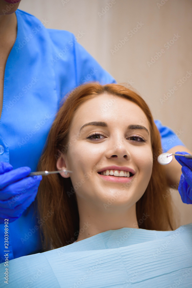 Dentist examining a patient's teeth in the dentist. Dentist examining a patient's teeth in the dentist.