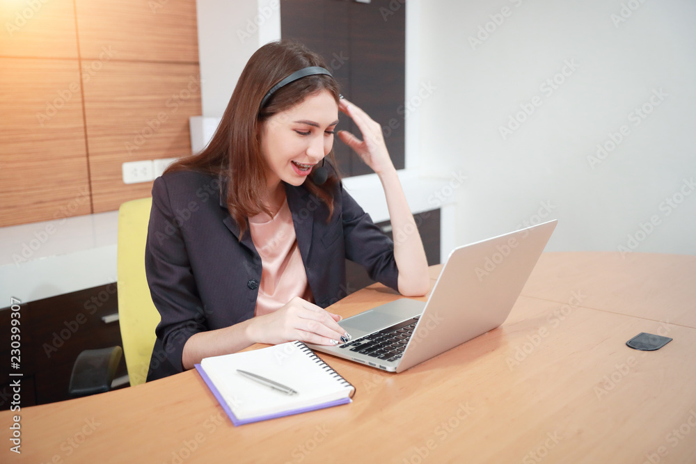 portrait of beautiful call center woman with headphones and computer portrait of beautiful call center woman with headphones and computer