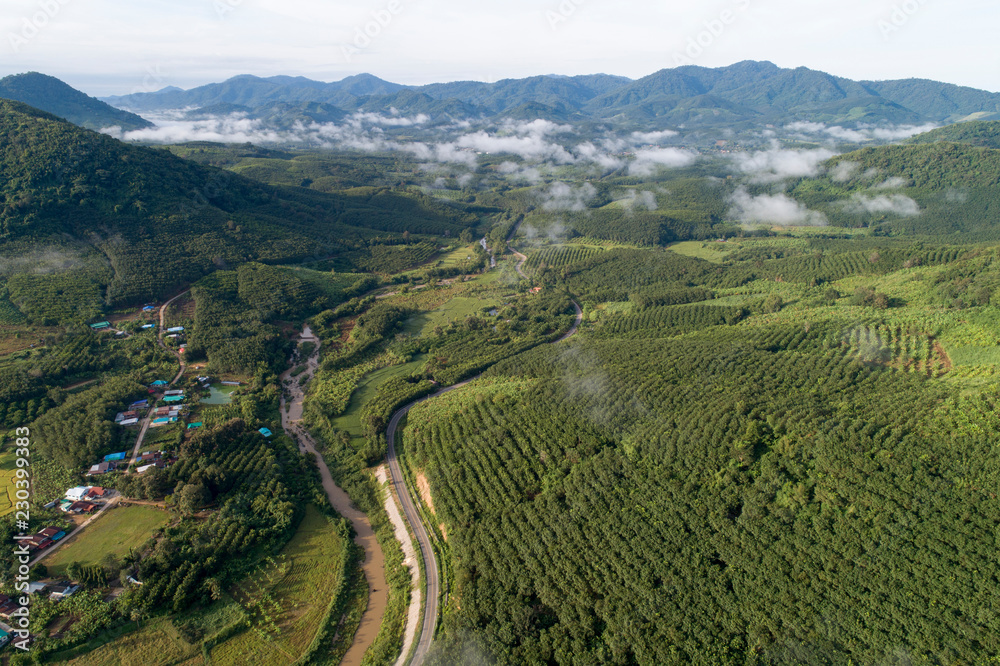 Aerial view country village with mountain and mist fog during morning time in asia thailand