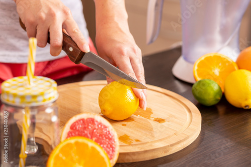 Woman cutting lemon on a cutting board