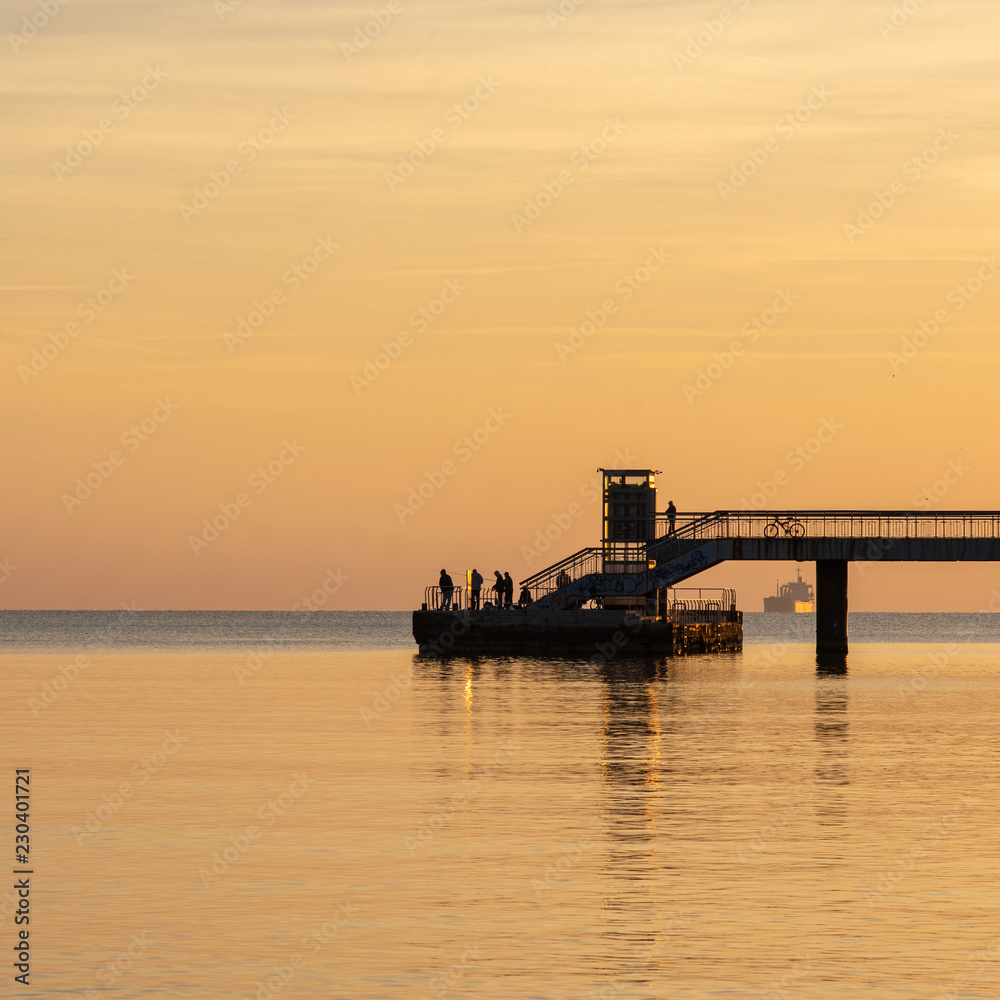 Fishermen on the pier at sunrise