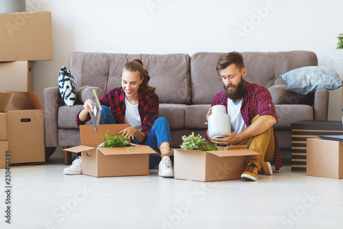 happy young married couple moves to new apartment.