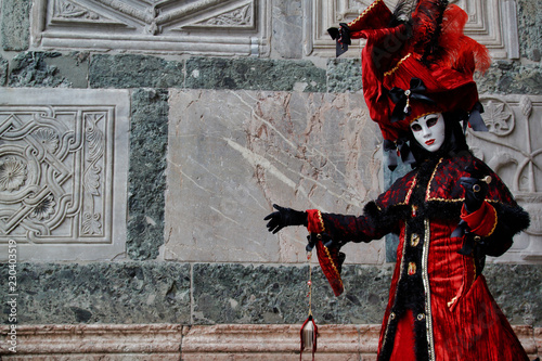 Carnival red-black mask and costume at the traditional festival in Venice, Italy