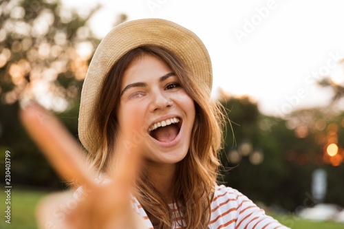 Close up of smiling young girl in summer hat