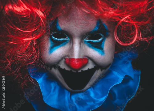 Creepy clown close up halloween portrait on black background