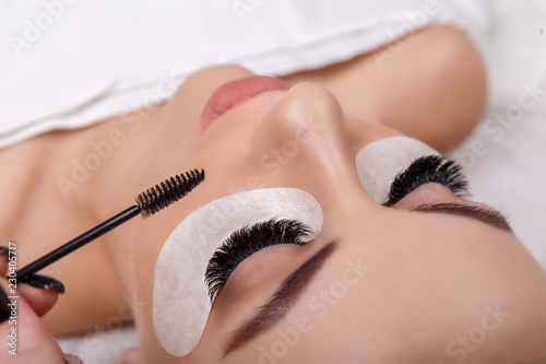 Eyelash Extension Procedure. Woman Eye with Long Eyelashes. Close up, selective focus. Hollywood, russian volume photo