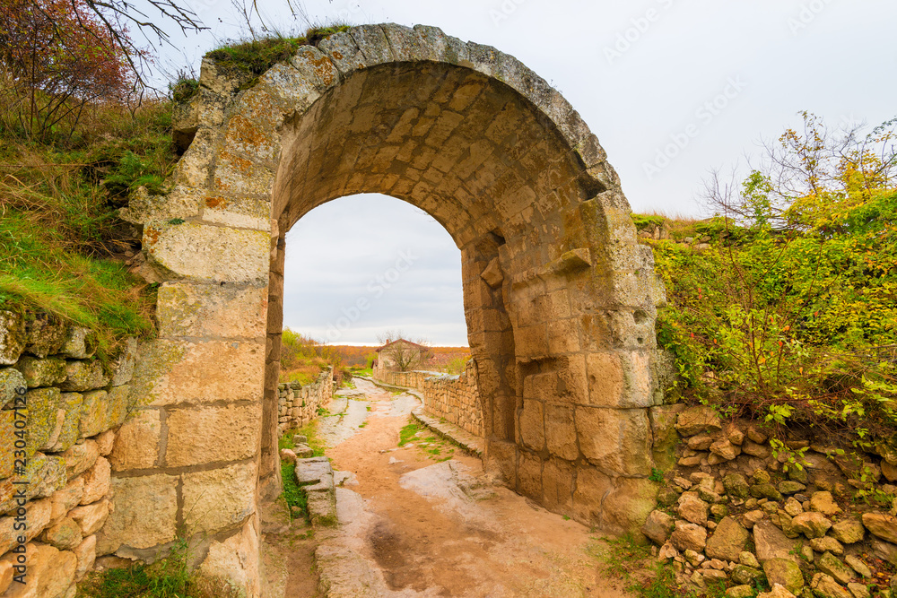 Stone old arch - architectural detail of the city of Chufut-Kale with caves, Crimea, Russia