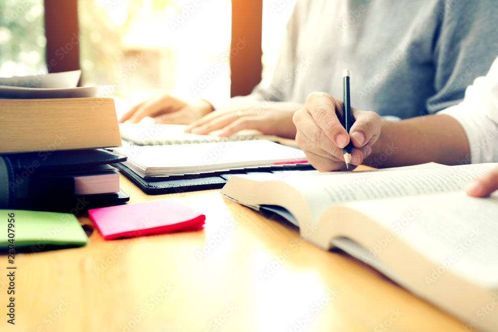 Teenage student works on homework in his room and writing in notebook. Teenage student works on homework in his room and writing in notebook.