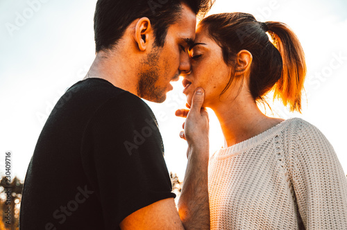 Couple in love kiss outdoor at sunset