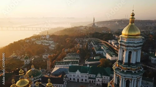 Most inetersting places of Kiyv Ukraine. Kiev Pechersk Lavra. Aerial drone video footage. View to rider Dnipro and The Motherland Monument. Fog and sunrise light. Lovely morning mood photo