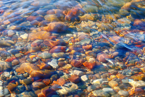 Colorful stones under water. The concept of meditation, contemplation, peace and silence