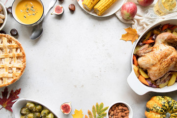 Thanksgiving dinner with chicken, apple pie, pumpkin soup brussel sprouts and fruits.