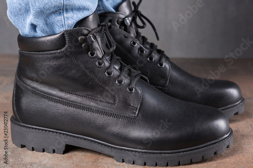 pair of men's shoes on the feet, on the grunge surface, autumn shoes side view, close-up shot