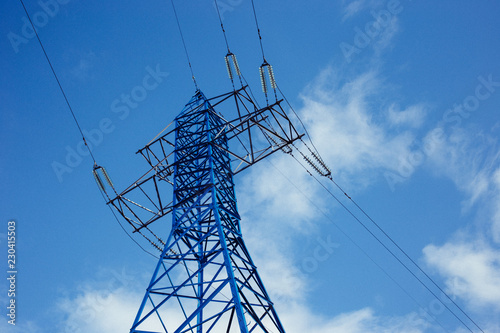 bottom view of the tower of power grids on blue sky background  High voltage  Electricity concept