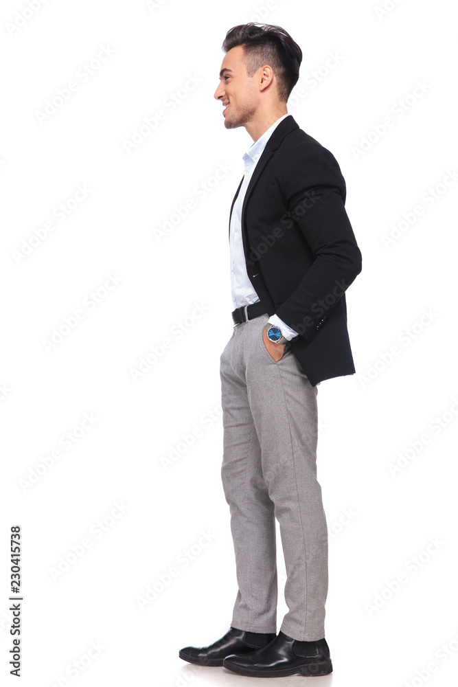 relaxed busiessman with hands in pockets waiting in line relaxed busiessman with hands in pockets waiting in line