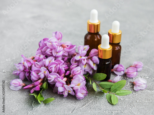 Essential oils and pink acacia flowers