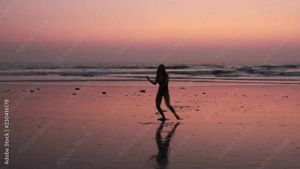 Unidentified woman practicing karate on the beach Unidentified woman practicing karate on the beach
