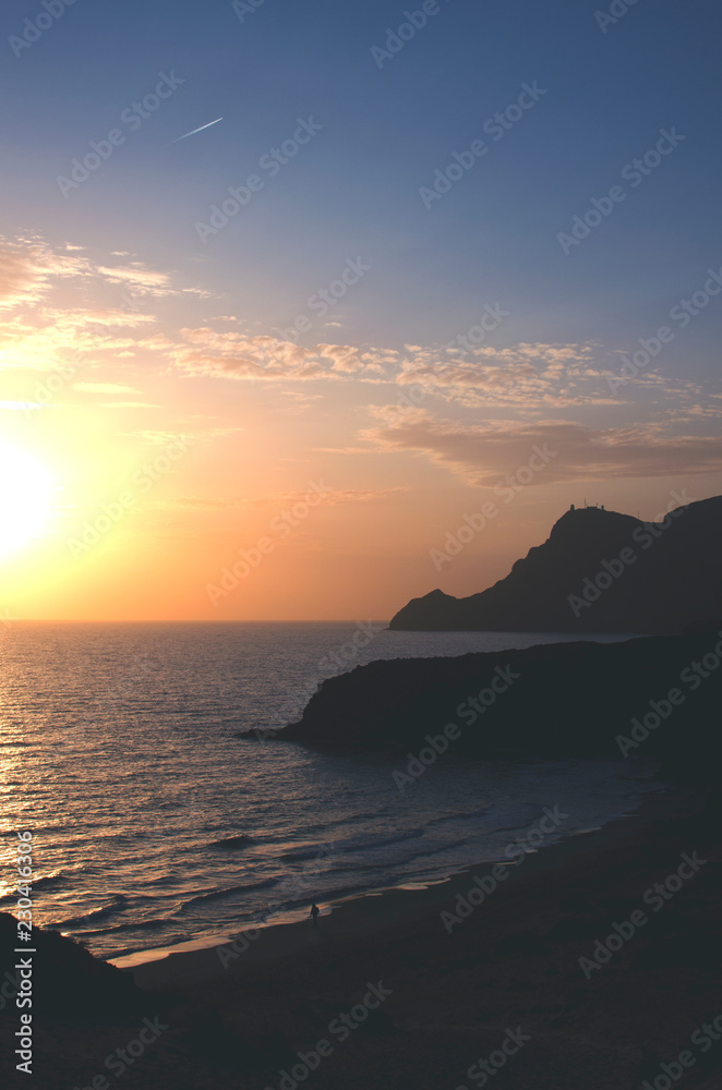 Mediterranean coastline, lonely beach and mountains in Cabo de Gata at sunset. Cala Barronal, Almeria, Andalucia, Spain