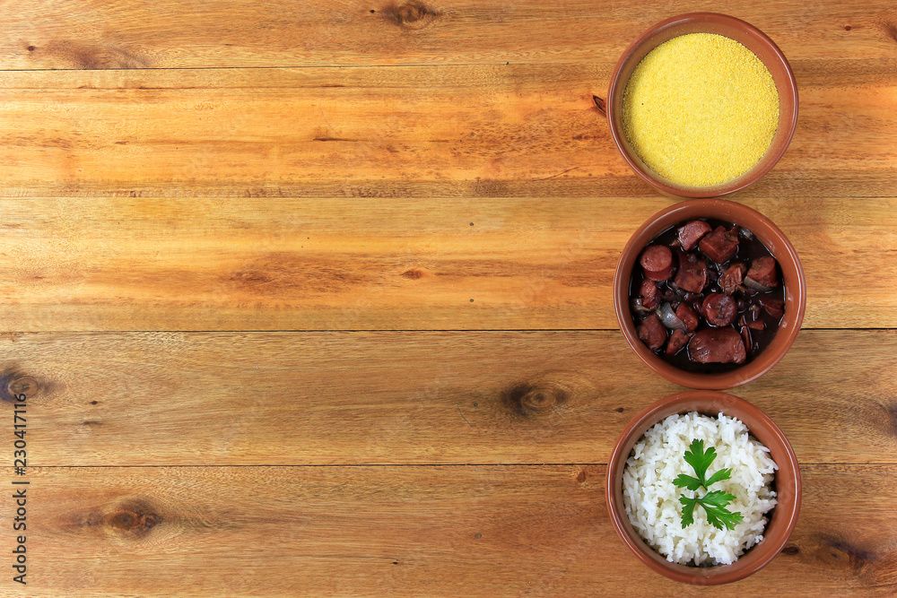 Brazilian feijoada, traditional dish of the Brazilian cuisine, on wooden table Brazilian feijoada, traditional dish of the Brazilian cuisine, on wooden table