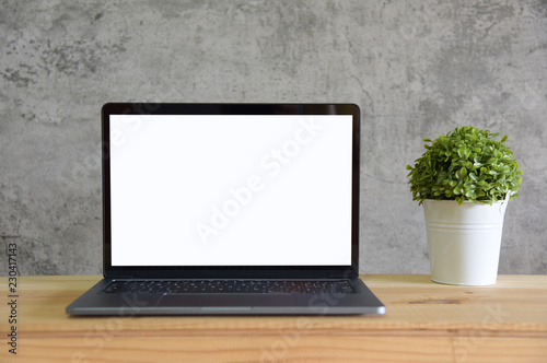 Blank screen Laptop with copy space on wooden table in room Loft style
