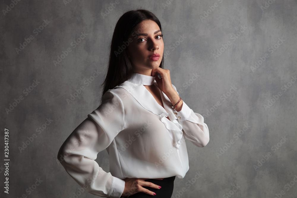 businesswoman standing with hnd on waist and neck