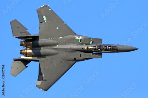 Fighter bomber aircraft flying top down aerial view silhouette isolated on blue sky with pilots in cockpit air force military army theme design reference background