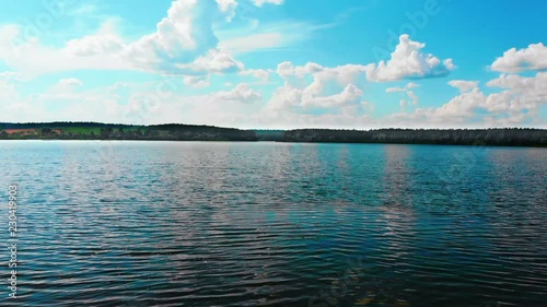 Ruza, Russia - August 2018: The girl on a wonderful lake. Blue sky with beautiful clouds. photo