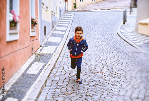  Portrait of a boy running up the street
